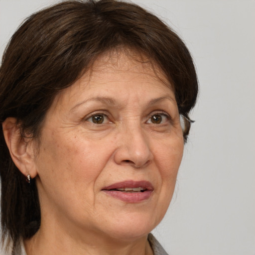 Joyful white middle-aged female with medium  brown hair and brown eyes