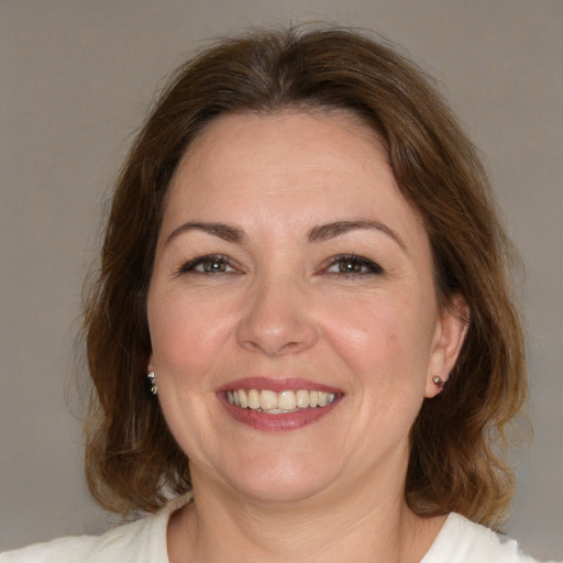 Joyful white adult female with medium  brown hair and brown eyes