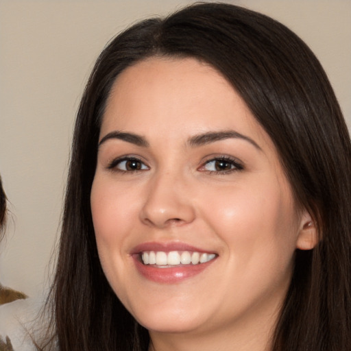 Joyful white young-adult female with long  brown hair and brown eyes