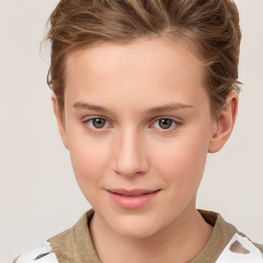 Joyful white child female with short  brown hair and grey eyes