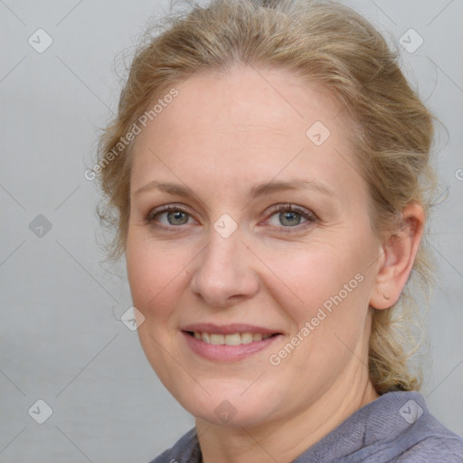 Joyful white adult female with medium  brown hair and blue eyes