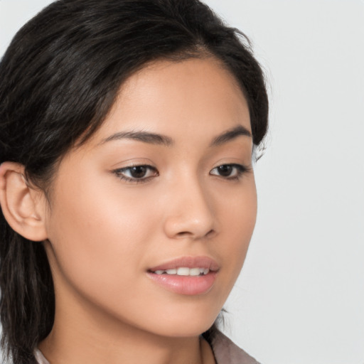 Joyful asian young-adult female with long  brown hair and brown eyes