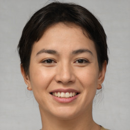 Joyful asian young-adult female with short  brown hair and brown eyes