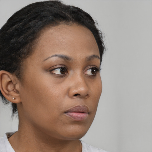 Neutral black young-adult female with medium  brown hair and brown eyes