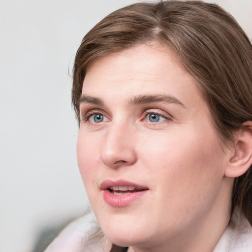 Joyful white young-adult female with medium  brown hair and blue eyes