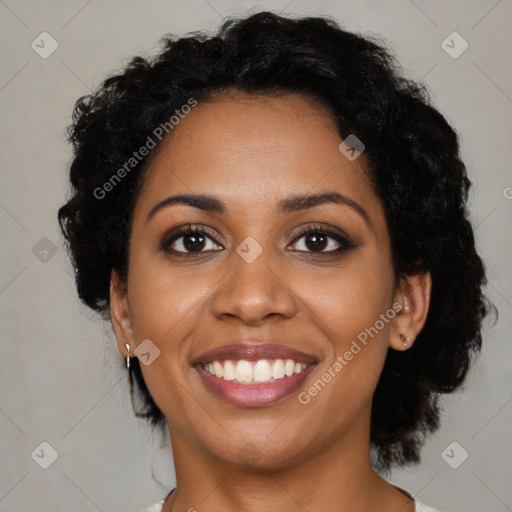 Joyful black young-adult female with medium  brown hair and brown eyes