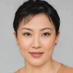 Joyful asian young-adult female with short  brown hair and brown eyes