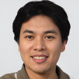 Joyful asian young-adult male with short  black hair and brown eyes