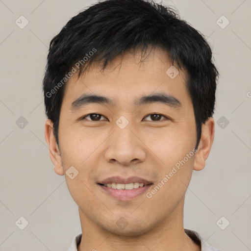 Joyful asian young-adult male with short  black hair and brown eyes