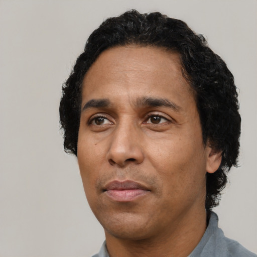 Neutral latino adult male with short  black hair and brown eyes