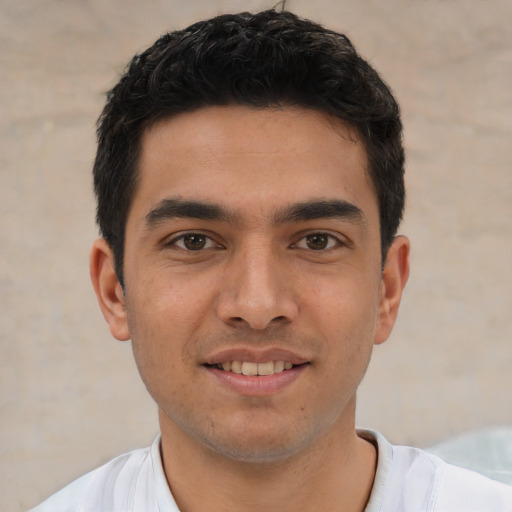 Joyful white young-adult male with short  black hair and brown eyes