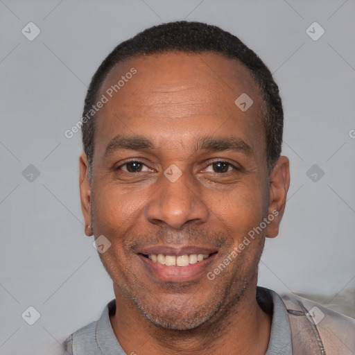 Joyful latino adult male with short  black hair and brown eyes