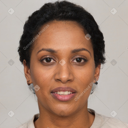 Joyful black adult female with short  black hair and brown eyes