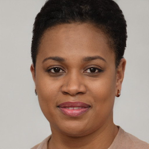 Joyful black young-adult female with short  brown hair and brown eyes