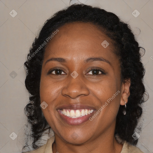 Joyful black adult female with long  brown hair and brown eyes