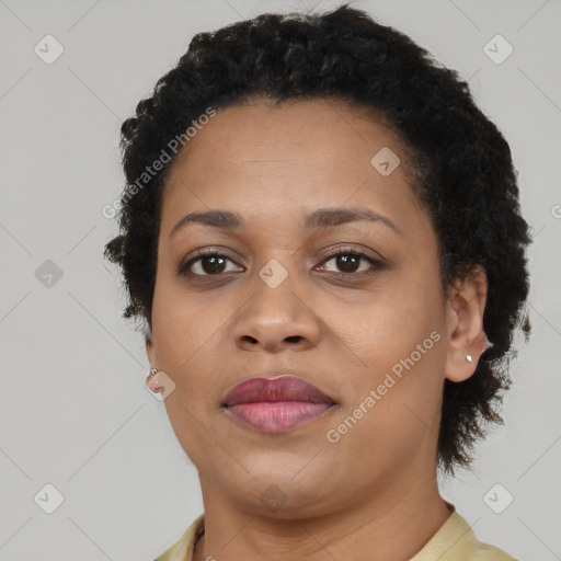 Joyful black adult female with short  brown hair and brown eyes