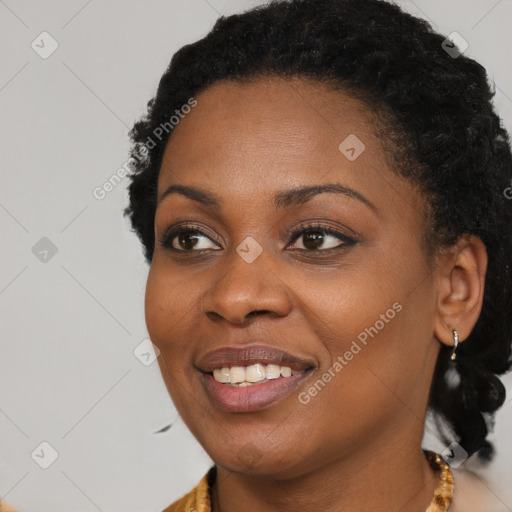 Joyful black young-adult female with long  black hair and brown eyes