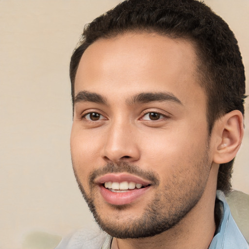 Joyful white young-adult male with short  black hair and brown eyes