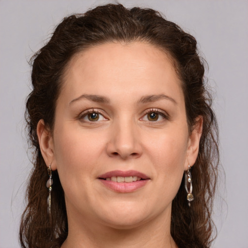 Joyful white young-adult female with long  brown hair and green eyes