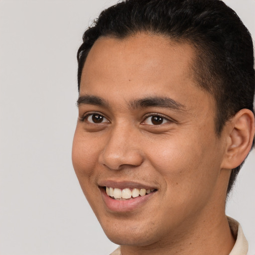 Joyful latino young-adult male with short  brown hair and brown eyes
