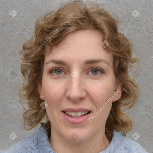 Joyful white adult female with medium  brown hair and blue eyes