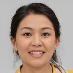 Joyful asian young-adult female with medium  brown hair and brown eyes