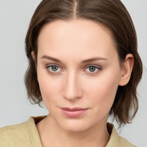 Neutral white young-adult female with medium  brown hair and grey eyes