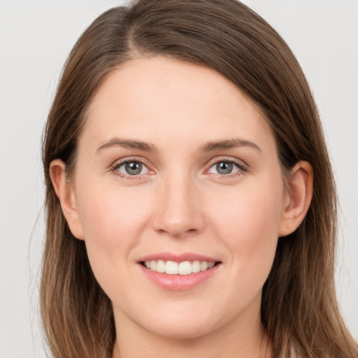 Joyful white young-adult female with long  brown hair and grey eyes