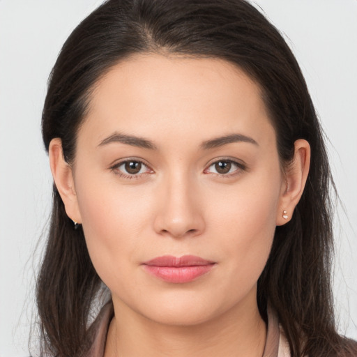 Joyful white young-adult female with long  brown hair and brown eyes