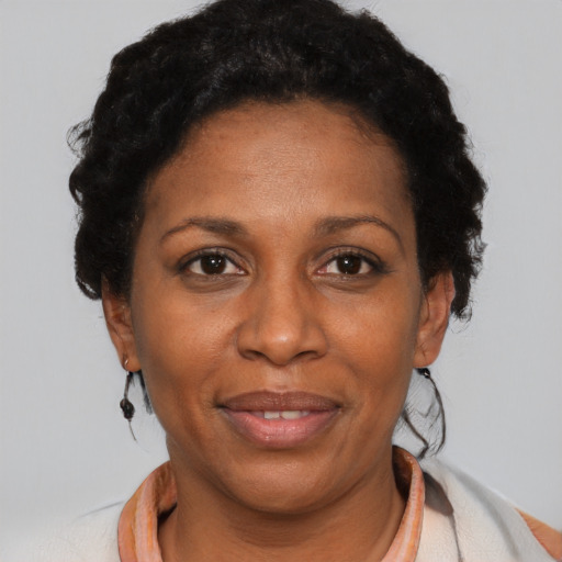 Joyful black adult female with short  black hair and brown eyes