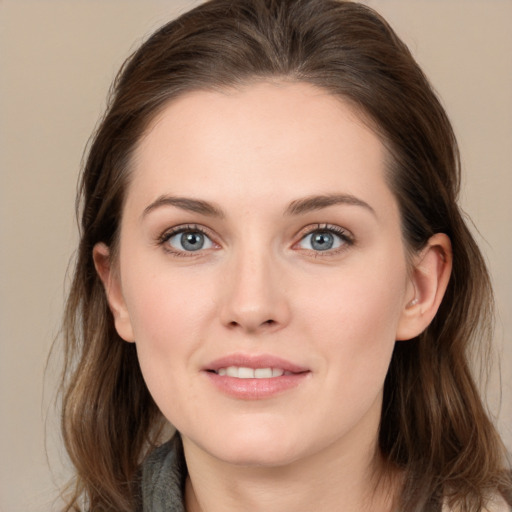 Joyful white young-adult female with long  brown hair and grey eyes