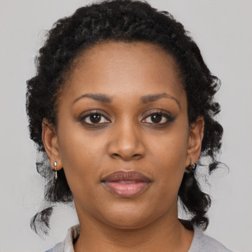 Joyful black young-adult female with medium  black hair and brown eyes