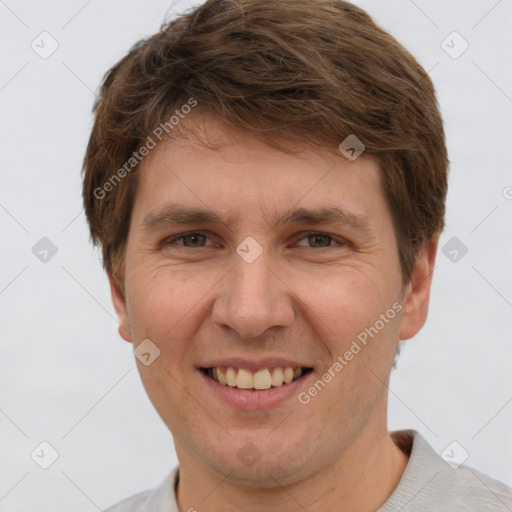 Joyful white adult male with short  brown hair and grey eyes