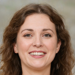 Joyful white young-adult female with long  brown hair and green eyes