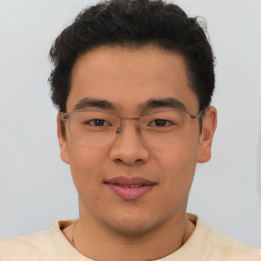 Joyful latino young-adult male with short  brown hair and brown eyes