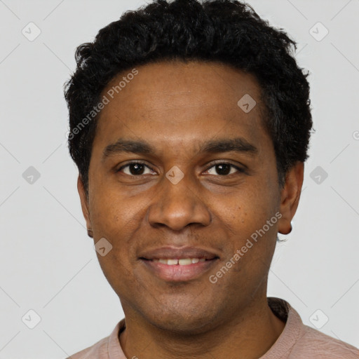 Joyful black young-adult male with short  black hair and brown eyes