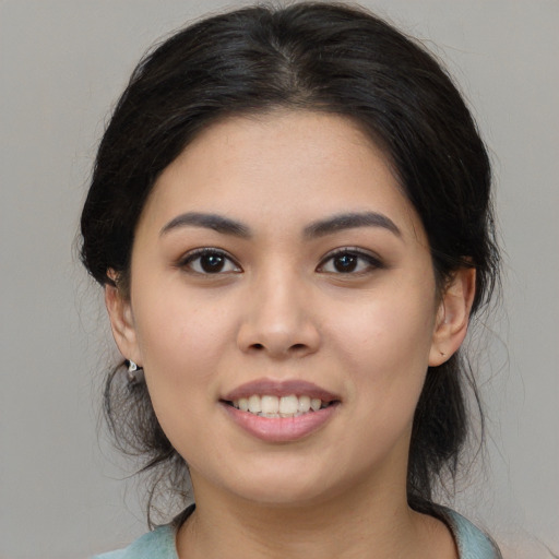 Joyful asian young-adult female with medium  black hair and brown eyes
