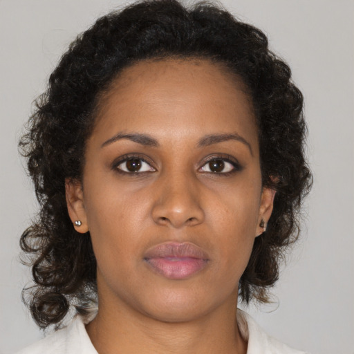Neutral black young-adult female with medium  brown hair and brown eyes