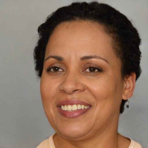 Joyful latino adult female with short  brown hair and brown eyes
