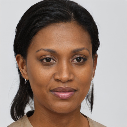 Joyful black young-adult female with medium  brown hair and brown eyes