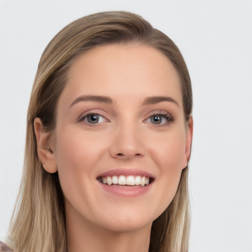 Joyful white young-adult female with long  brown hair and grey eyes