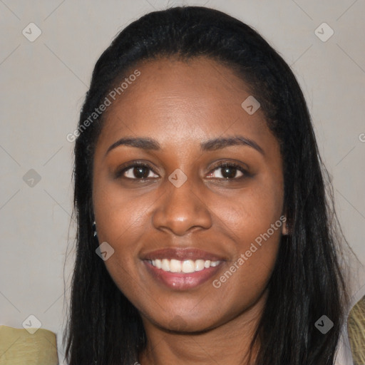 Joyful black young-adult female with long  black hair and brown eyes