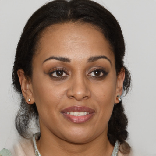 Joyful black young-adult female with medium  brown hair and brown eyes
