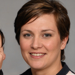 Joyful white adult female with medium  brown hair and brown eyes