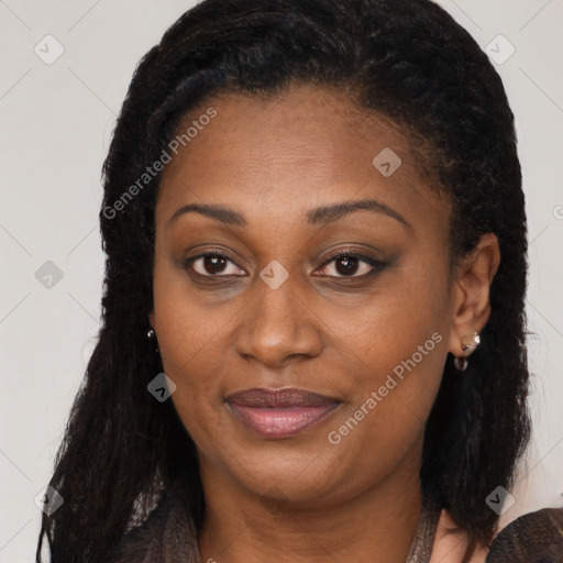 Joyful black adult female with long  brown hair and brown eyes