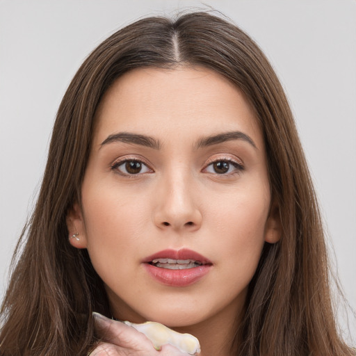 Neutral white young-adult female with long  brown hair and brown eyes