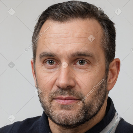 Joyful white adult male with short  brown hair and brown eyes