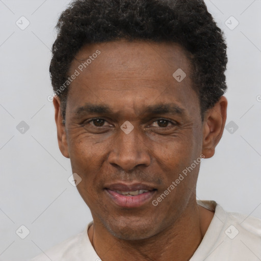 Joyful black adult male with short  black hair and brown eyes