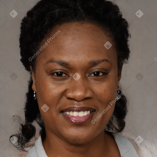 Joyful black adult female with medium  brown hair and brown eyes