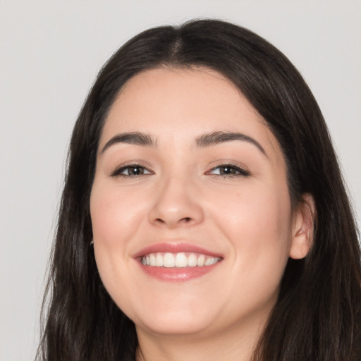 Joyful white young-adult female with long  black hair and brown eyes